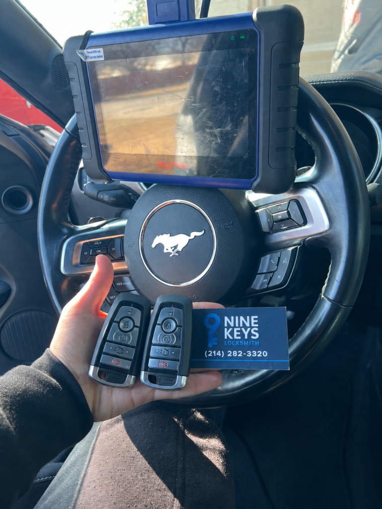 Automotive locksmith programming replacement key fobs for a Ford Mustang